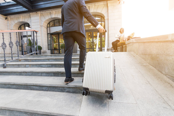 Man holding suitcase. businessman with luggage travels, goes to a business meeting - Fotoğraf, Görsel