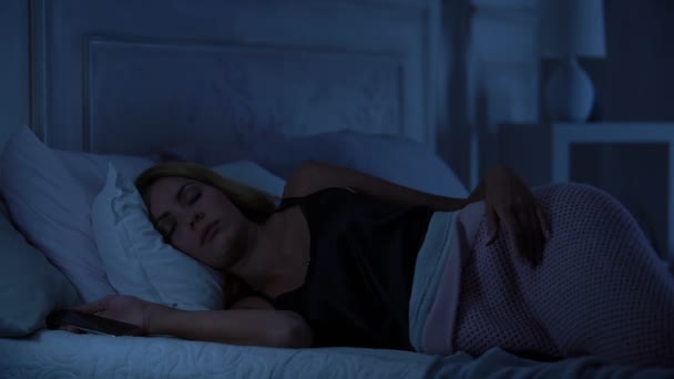 Beautiful woman sleeping with smartphone in hands, gadget addiction, application - Metraje, vídeo