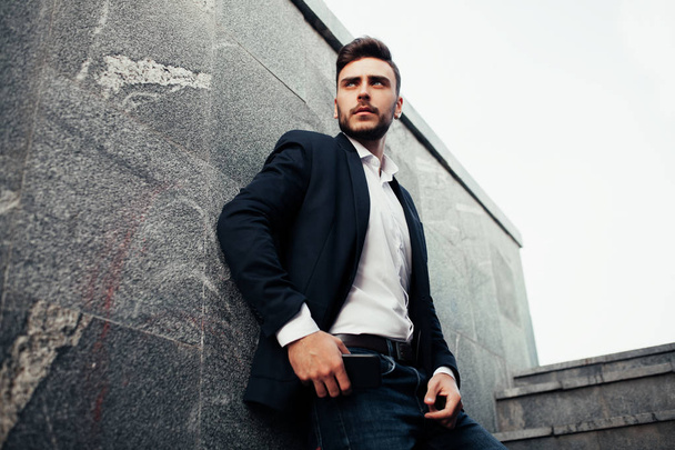 Young stylish businessman man with a beard in a fashionable suit and jeans.  - Foto, Imagem