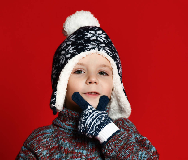 gyermek fiú polár sál, pulóver és ujjatlan szórakozás felett színes piros háttér. - Fotó, kép