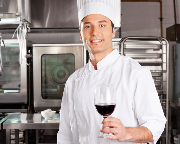 Young Chef Holding Wine Glass - Фото, изображение