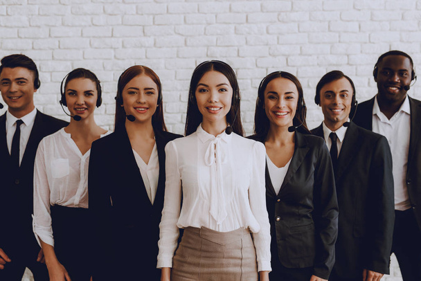 Young Smiling Managers Standing in Modern Office. Training in Office. Modern Office Concept. Smiling Worker. Standing in Room. Woman in White Shirt. Man in Black Suit. White Wall in Office. - Fotoğraf, Görsel