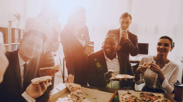 Team of Managers Have Lunch in Modern Office. Rest after Business Meeting. Modern Office Concept. Cooperation with Colleagues. Businessman with Team. Pizza in Box. Businessman in Suit. - Foto, imagen
