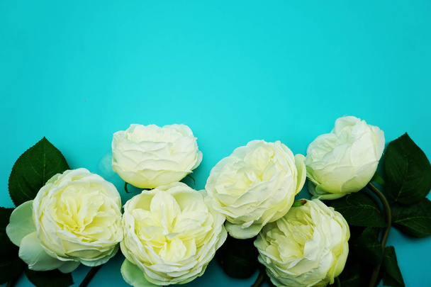 top view space copy with artificial white peony flowers bouquet on b;ue background - Zdjęcie, obraz