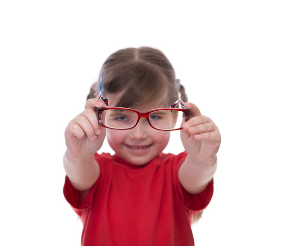 Cute little girl holding glasses and looking thru it - Фото, зображення