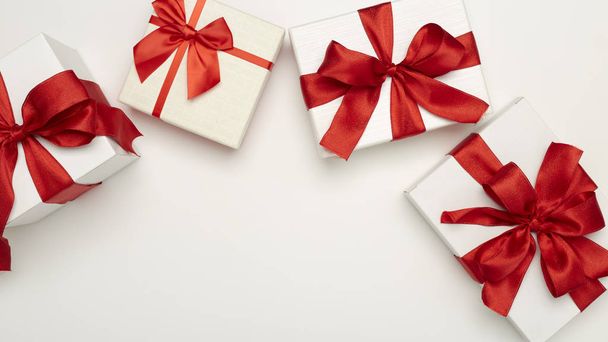 праздничные подарочные коробки с красными бантами
 - Фото, изображение