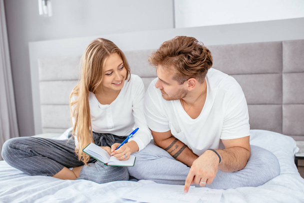 two happy young people are going to design their bedroom - Valokuva, kuva