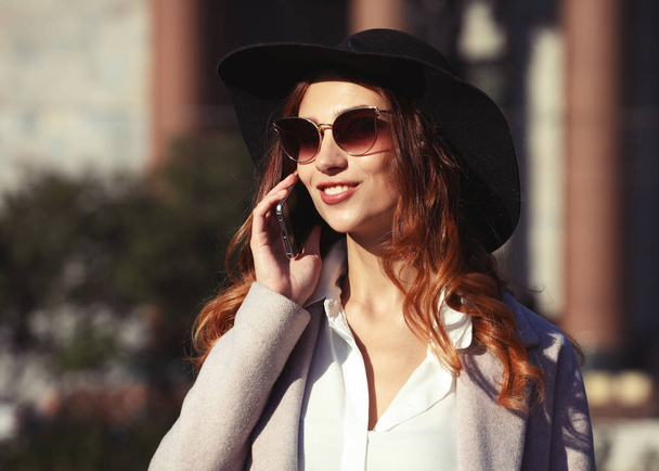 smiling young woman calling and talking on smartphone in the aut - Foto, immagini