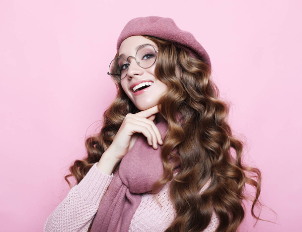 beautiful young female model with long wavy hair wearing pink beret , scarf and eyeglasses - Φωτογραφία, εικόνα