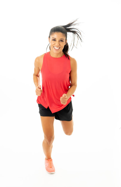 Young attractive happy latin woman in sport clothes with beautiful smile running and training on jogging workout isolated on white background in fitness healthy lifestyle concept. - Foto, immagini