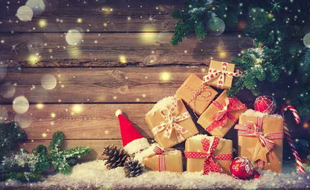 Christmas background with decorations and gift boxes on wooden board - Foto, immagini