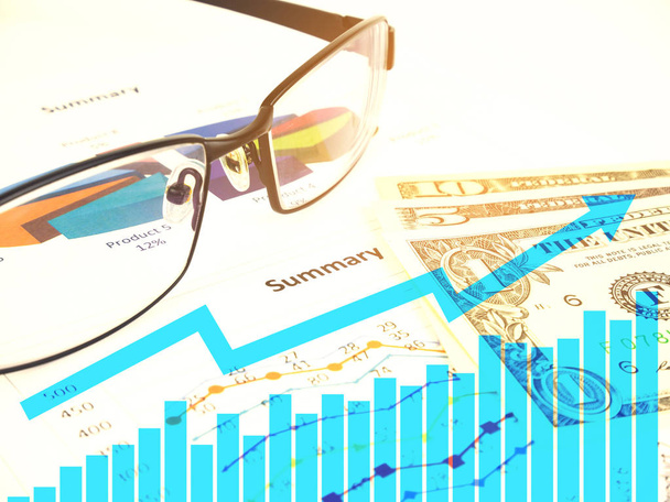 Business chart near dollars by unfocused glasses, Concept financier
. - Photo, image