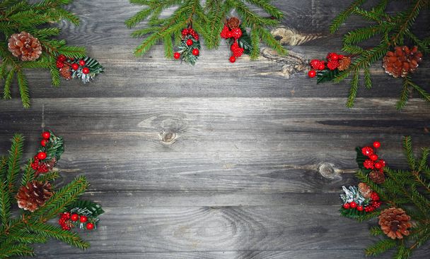 christmas background and decoration with fir branches garland lights on old wooden board copy space - Photo, Image