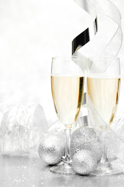 Glasses of champagne and  christmas decorative balls on glitter background - Fotoğraf, Görsel