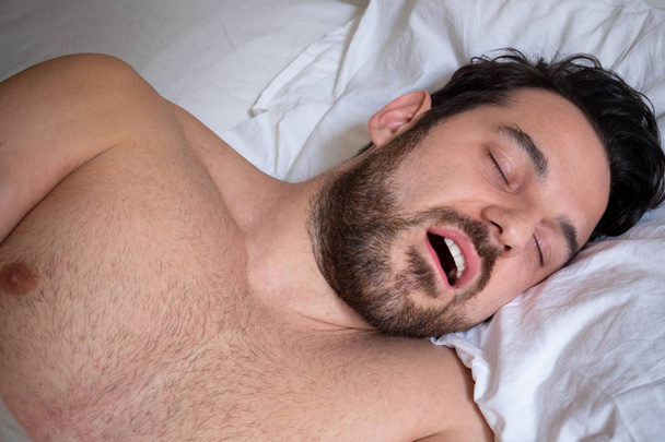 Man face expression snoring and suffering apnea - Fotografie, Obrázek
