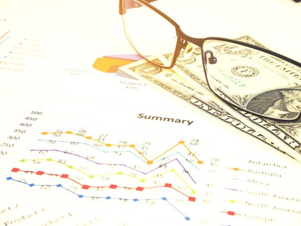 Business chart near dollars by unfocused glasses, Concept financier
. - Photo, image