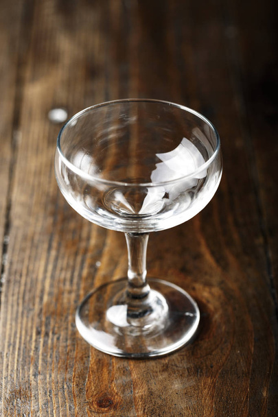 empty cocktail glass on a brown wooden tabl - Zdjęcie, obraz