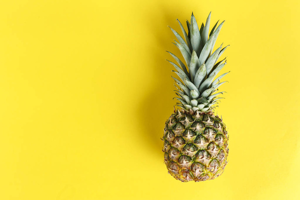 whole pineapple on a bright yellow background. space for tex - Φωτογραφία, εικόνα