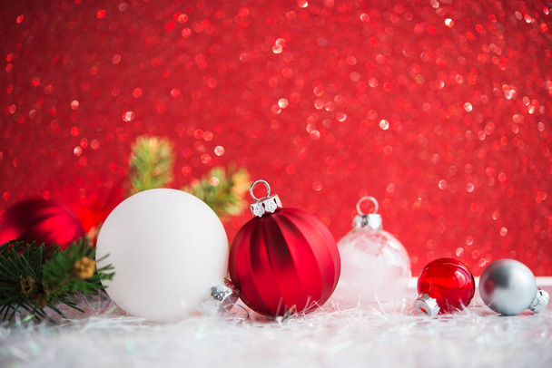 White, red and silver Christmas decorations on red glitter background - Photo, Image