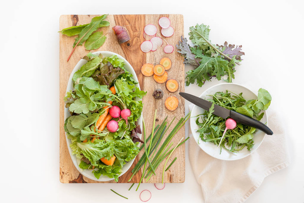 A scene of fresh produce ingredients on a wooden cutting block in a kitchen. - Photo, Image