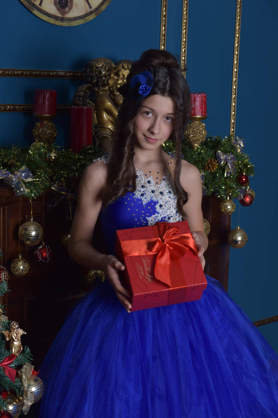 happy girl in blue dress with christmas present - Foto, Imagem