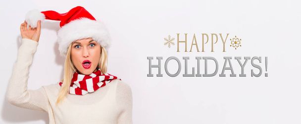 Happy holidays message with woman with Santa hat - Фото, зображення