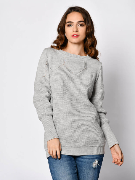 Young beautiful woman posing in new casual grey blouse sweater - Фото, изображение