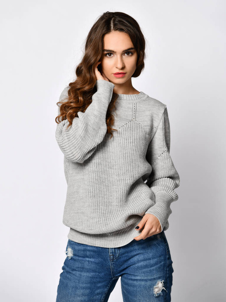 Young beautiful woman posing in new casual grey blouse sweater - Fotoğraf, Görsel