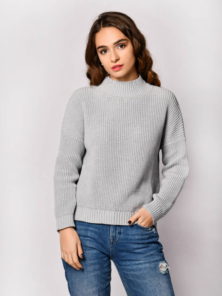Young beautiful woman posing in new casual grey blouse sweater - Photo, Image
