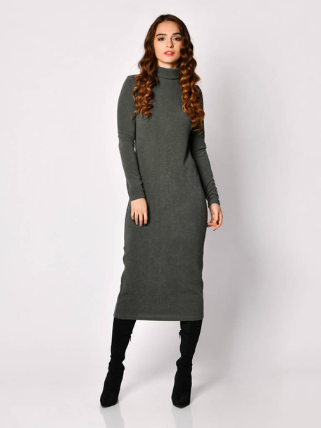 Young beautiful woman posing in new gray fashion winter knitted dress smiling - Фото, изображение