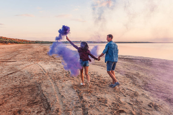 young couple running with hand flare or fusee - Foto, immagini