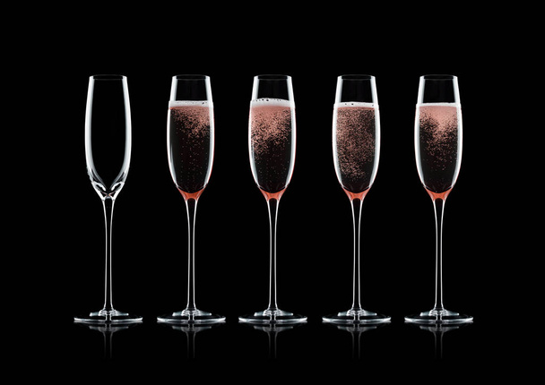 Rose pink champagne glasses with bubbles on black background with reflection - Photo, Image