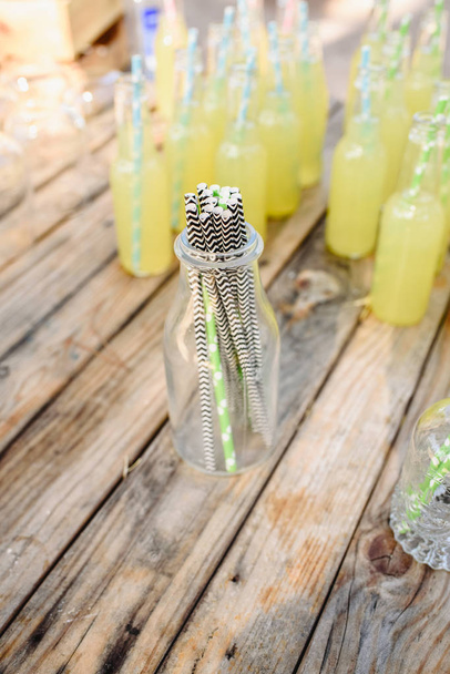 Drinking straws of paper to drink lemonade in glass bottle. - Photo, Image