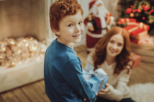 Handsome boy celebrating Christmas with his mommy - Valokuva, kuva
