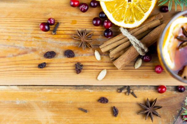 Christmas hot drink with cinnamon and spices on a wooden background. Winter hot drink - Photo, Image