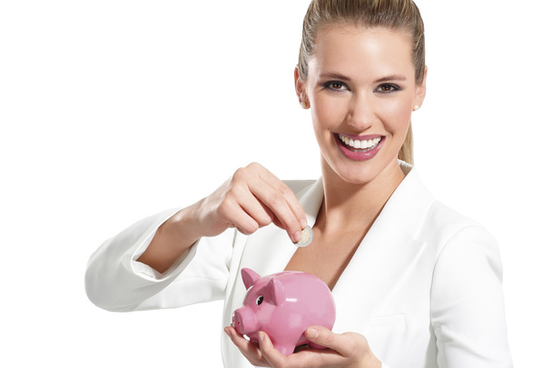 Young beautiful woman standing with piggy bank money box - Photo, Image