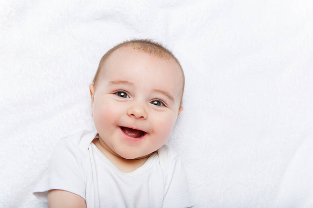 glücklich schöner kleiner Junge im weißen Body-Anzug - Foto, Bild