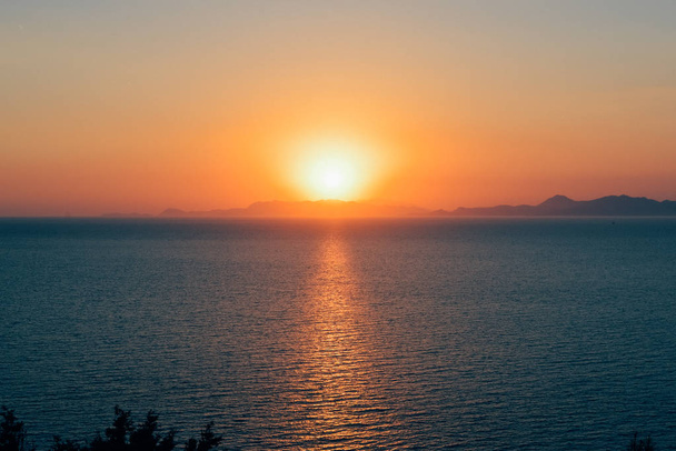 RHODES, GREECE - CIRCA JUNE 2018: Aegean Sea at the sunset on the west edge of Rhodes island, Greece. - Photo, image