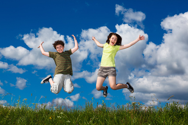 Girl and boy running, jumping outdoor - Photo, image
