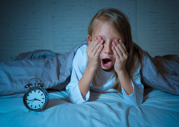 niedlichen schlaflosen kleinen Mädchen im Bett wach in der Mitte der Nacht müde aussehend Probleme beim Einschlafen in der Nacht oder zu früh aufwachen bei Schlaflosigkeit Angst Schlafstörungen bei Kindern. - Foto, Bild
