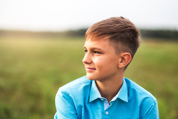 portrait of a cute teen boy in summer in nature - Valokuva, kuva