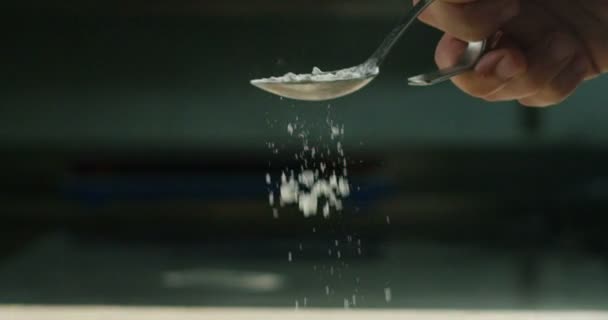 in an Italian professional kitchen a chef pours salt on a dish or in the water to boil the Italian pasta concept of healthy and light food. bio - Filmagem, Vídeo