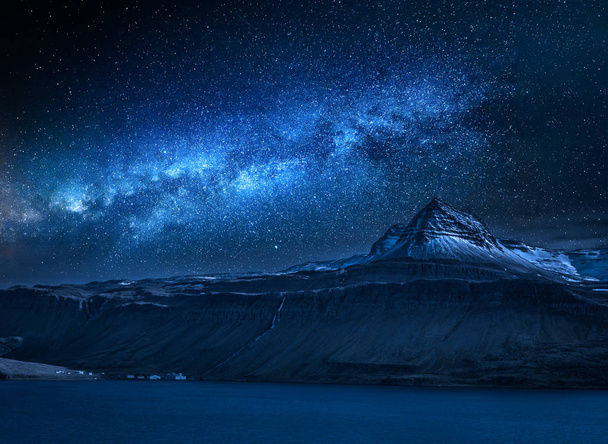Milky way over volcanic mountain over fjord at night, Iceland - Fotó, kép