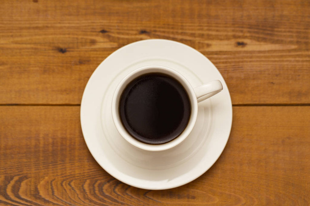 Cup of coffee on wooden background - Фото, зображення