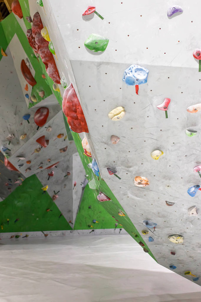 Climbing wall in the boulder hall with colored hooks - Zdjęcie, obraz