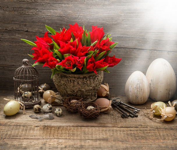 vintage easter composition with eggs and red tulips - 写真・画像