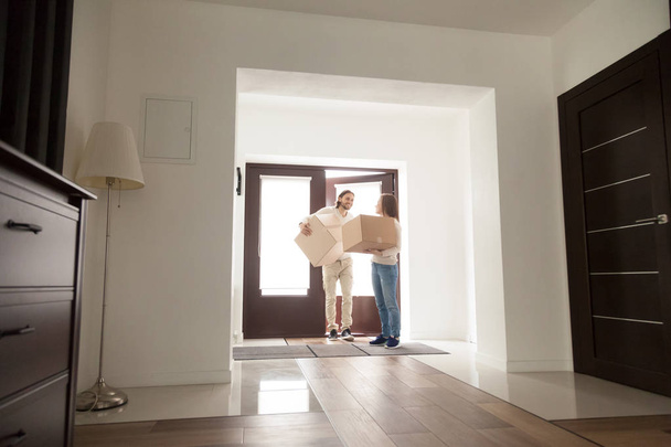 Couple arrived at new house with cardboard boxes - Photo, Image