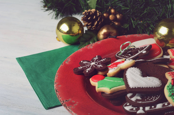 Plate with colorful christmas cookies on wooden table. xmas holiday concept. - Φωτογραφία, εικόνα