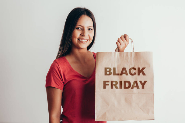 Portrait of casual woman with Black Friday paper bag - Photo, Image