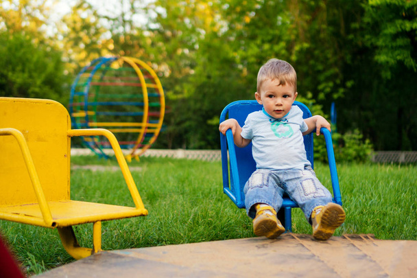 baby boy playing in the playground Kid play outdoors on warm sunny summer day. - Foto, Imagem